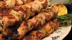 several skewers of meat and vegetables on a plate