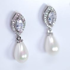 These Beautiful Romantic  BRIDAL EARRINGS are crafted with the finest quality of Faux Peatls and AAA+ CZ crystals and are plated with white gold to ensure a luxurious and radiant shine on your special day! The simulated diamonds used in these earrings, also known as diamond simulants, are made of materials such as cubic zirconia (CZ), moissanite, and YAG. These materials, while not possessing the same chemical and physical properties as actual diamonds, can still provide a stunning and radiant l Classic Pear-shaped Bridal Earrings For Party, Classic Pear-shaped Pearl Earrings For Wedding, Classic Teardrop Jewelry For Mother Of The Bride, Elegant Round Teardrop Earrings For Wedding, Classic Teardrop Bridal Earrings For Mother Of The Bride, Elegant Teardrop Pearl Earrings For Bridesmaid Gift, Classic Teardrop Earrings For Mother Of The Bride, Earring Bridal, Bridal Earring