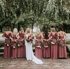 the bride and her bridesmaids are all wearing burgundy dresses