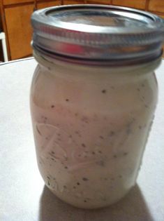 an image of a jar with food in it sitting on a table next to the caption