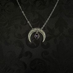 "This simple pendant features a richly detailed antiqued silver tone crescent, adorned with dazzling dark purple glass crystals. Pendant is 1 1/8\" wide and 1\" tall.  Necklace length is adjustable with soldered stainless steel cable chain, lobster clasp and extender. If you would like a different length, please send us a message. Matching headpiece, pendant and earrings are listed separately in our store. If you don't see items with a color you want, feel free to ask about availability." Gothic Jewelry With Moon Charm, Gothic Silver Crescent Necklace, Gothic Crescent Silver Necklace, Gothic Purple Metal Jewelry, Gothic Crescent Moon Charm Jewelry, Gothic Festival Jewelry With Moon Charm, Witchy Metal Jewelry With Moon Charm, Silver Metal Witchy Jewelry, Silver Witchy Metal Jewelry