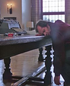 a man leaning over a table in a living room