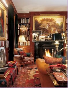 a living room filled with furniture and bookshelves next to a painting on the wall