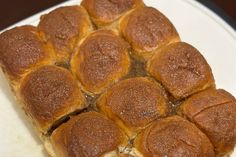 a plate that has some kind of bread on it with other items in the background