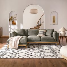 a living room filled with furniture and a rug