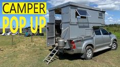 a truck with a camper on the back and ladder up to it's bed