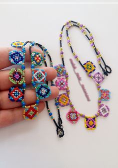 someone is holding some beaded necklaces in their hand and it looks like they are made out of beads