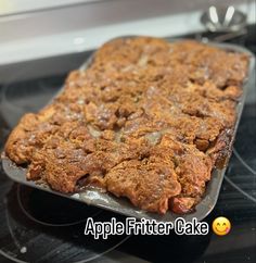 a baking pan with some food on top of it and the words apple fitter cake above it