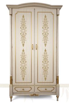 a white and gold armoire with ornate designs on the front, two doors open