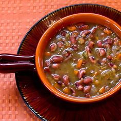 a bowl filled with beans on top of a table