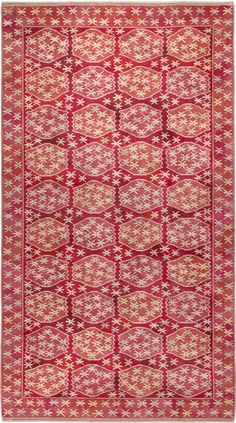 a red and white rug with an intricate design