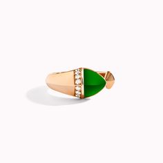 a gold ring with green and white stones on the front, set in 18k rose gold