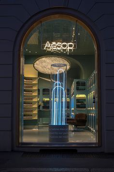 the entrance to aessop is lit up at night