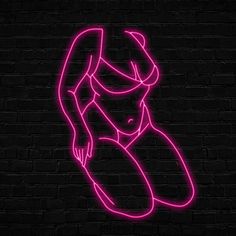 a neon sign that is on the side of a brick wall with a woman's face