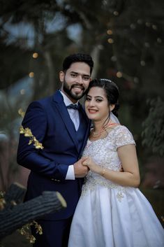 a bride and groom pose for a wedding photo