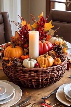 a wicker basket filled with pumpkins and other autumn decorations