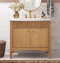 a bathroom with a sink, mirror and rug on the floor in front of it