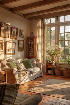 a living room filled with lots of furniture next to a large window covered in sunlight