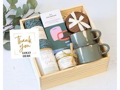 a wooden box filled with coffee, tea and crochet work items on top of a white table