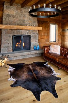 a living room filled with furniture and a fire place next to a stone wall fireplace