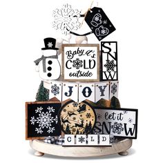 a snowman is on top of a christmas cake with black and white decorations around it