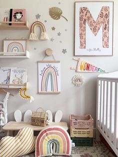 a child's room with lots of pictures on the wall and toys in baskets