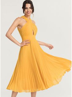 a woman in a yellow dress posing for the camera with her hands on her hips