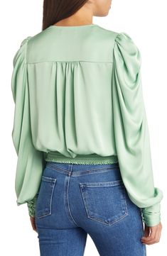 A serene shade and a lustrous fabric softly animate this graceful blouse styled with the season's abundant sleeves. 20" length (size medium) 100% polyester Dry clean Imported Formal Blouse With Draped Sleeves For Spring, Green Puff Sleeve Blouse For Spring, Silk V-neck Top With Blouson Sleeves, Spring Party Blouse With Draped Sleeves, Spring Evening Tops With Lantern Sleeves, Elegant Green Top With Gathered Sleeves, Spring Evening Lantern Sleeve Tops, Chic Green Top With Gathered Sleeves, Evening Tops With Lantern Sleeves For Spring