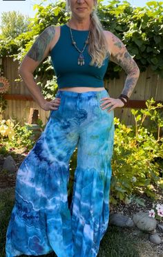 Made from 100% woven Rayon Light, these tiered pants have bohemian flare!   Comfortable and easy to wear with elastic waistband and two gathered tiers in the pant legs.  US Women's size small. measurements: waist: 14-21"(stretched) inseam: 32" rise: 14" hip: 23" Hippie Boho Print Vacation Bottoms, Casual Cotton Bottoms With Flared Hem, Flowy Ruffled Rayon Bottoms, Bohemian Blue Rayon Bottoms, Fitted Bohemian Festival Bottoms, Bohemian Blue Bottoms For Summer, Flowy Tiered Spring Bottoms, Summer Rayon Tiered Skirt, Flowy Tiered Bottoms For Spring