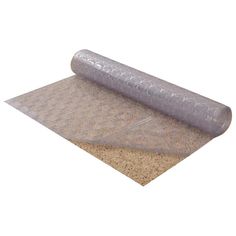 a rolled up mat on top of a cork flooring pad with a roll of plastic covering it