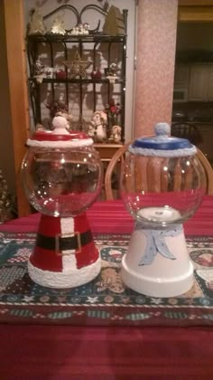 two fish bowls sitting on top of a table