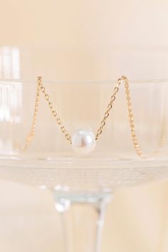 This yellow gold-plated pearl necklace is the perfect complement to any wedding day ensemble. There's something so chic about a necklace with a single pearl. Your bridesmaids will love wearing this necklace long after your big day. | Jewelry | Birdy Grey Crosby Single Pearl Necklace White Pearl Necklace With Delicate Chain For Formal Occasions, Elegant Pearl Bridal Necklace In Yellow Gold, Elegant Gold Bridal Necklace With Pearl Drop, Elegant Yellow Gold Pearl Bridal Necklace, Gold Pearl Bridal Necklace With Delicate Chain, Elegant Gold Bridal Necklace With Pearl Pendant, Dainty Pearl Charm Necklace For Formal Occasions, Classic Gold Pearl Necklace For Party, Elegant Yellow Gold Pearl Necklace For Wedding