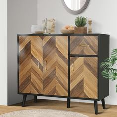 a sideboard with wooden chevron design and metal handles in a living room setting