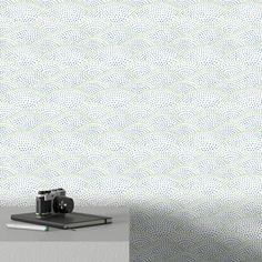 a camera sitting on top of a table next to a book