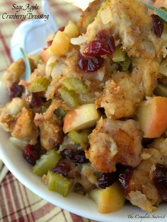 a white bowl filled with stuffing and fruit