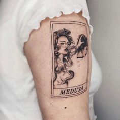 a woman's arm with a tattoo on it that reads medusa and features an image of two women