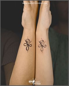 two women with matching tattoos on their arms