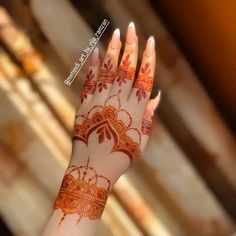 a woman's hand with henna on it