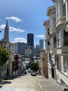 a city street lined with tall buildings and lots of windows on both sides of the street