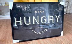 a window display with bananas in it on the floor next to a sign that says, stay hungry for success