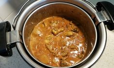 a pot filled with food sitting on top of a stove