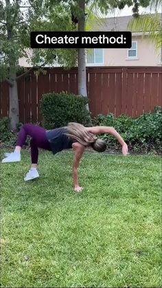 a woman is doing yoga outside in the grass with her hands behind her head and feet bent down