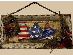 an american flag star is hanging on a wooden frame with red, white and blue decorations