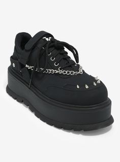 These edgy platform sneakers feature spike and chain accents. Comes with laces on the front and a self-fastening strap.Listed in women's sizes.2'' platformPolyurethane upper; rubber soleImported Punk Sneakers With Studded Rubber Outsoles For Streetwear, Punk Streetwear Sneakers With Studded Outsoles, Edgy Synthetic Platform Sneakers For Streetwear, Alternative Lace-up Sneakers For Streetwear, Edgy Black Platform Sneakers With Lug Sole, Edgy Lug Sole Platform Sneakers For Streetwear, Edgy Platform Sneakers With Lug Sole For Streetwear, Edgy Streetwear Platform Sneakers With Lug Sole, Edgy Leather Platform Sneakers For Streetwear