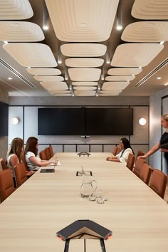 a group of people sitting around a conference table