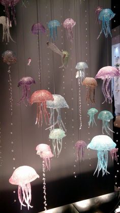 there are many jellyfish hanging from the ceiling