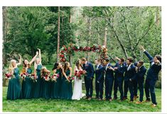 a group of people standing next to each other on top of a lush green field