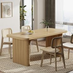 a wooden table with chairs around it in front of a large window and potted plant