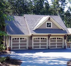 a large house with two car garages in the driveway