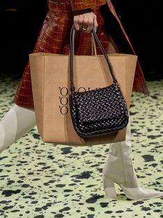 Bottega Veneta's Mini Cobble Bag features a padded version of the label's signature Intreccio woven pattern. The bag has one main compartment detailed with a clasp closure and comes with an adjustable shoulder. [tab] Composition: 100% Leather Size and Fit: Runs True to Size. 7.5"W x 6.75"H x 2.25"D. Origin: Made in Italy SKU: BOT48R1D1-BLK Questions about size, fit, or how to style? The KZ team is here to help you look and feel your best! Chat with our stylists via the icon below. Bottega Veneta Handbag, Fall 2023 Ready To Wear, Bottega Veneta Bag, Inspired Handbags, 2023 Ready To Wear, Detail Photos, Handmade Purses, Bag Trends, Fall 2023